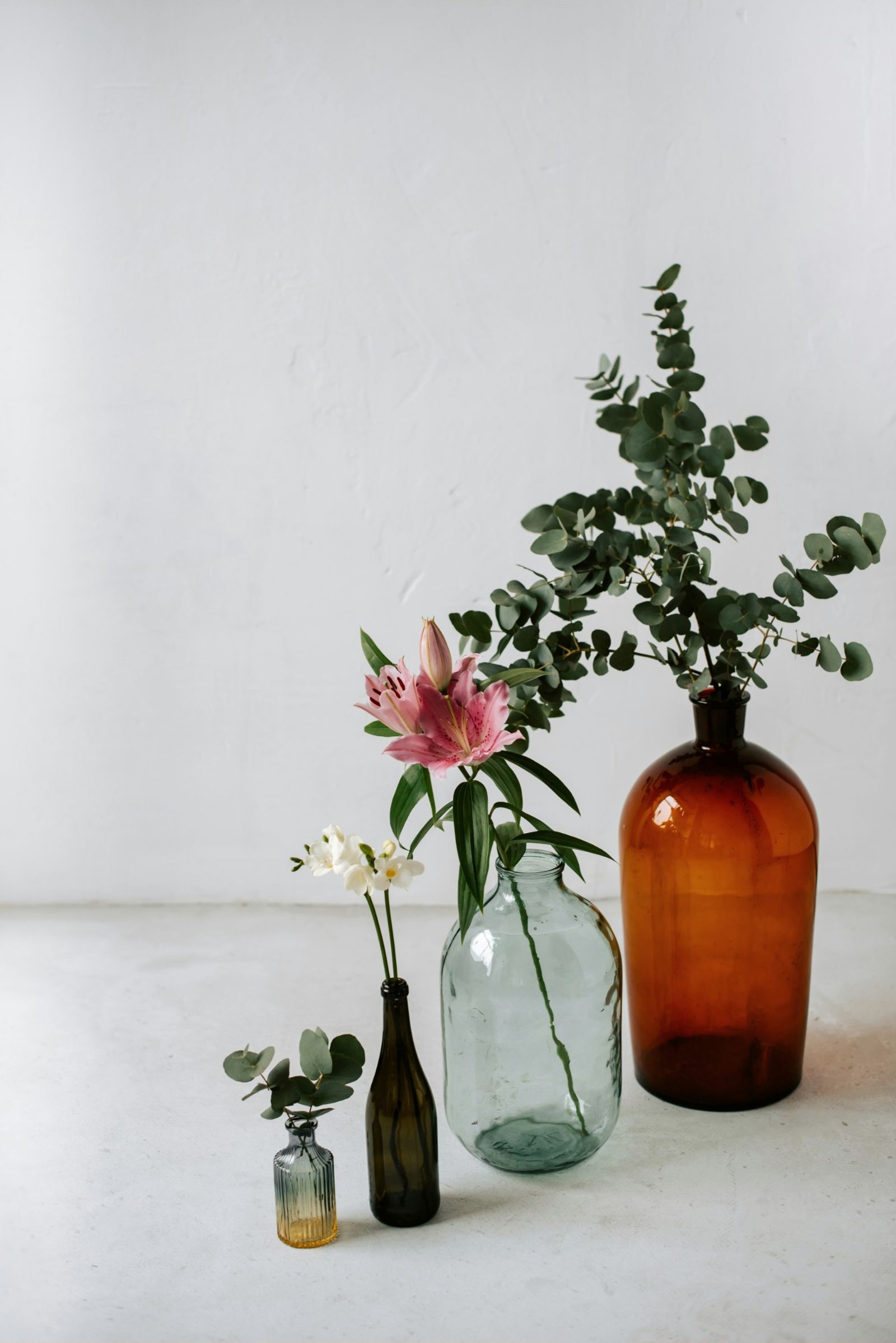 Amber glass bottles with fresh stems in soft light